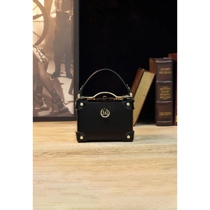 Vintage-style women's handbag in a suitcase design, patent leather, glossy wine red, luxury high-end crossbody shoulder bag
